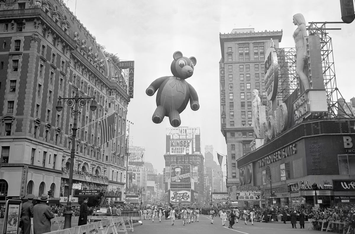 Tourists looking up at Bond sign during a parade