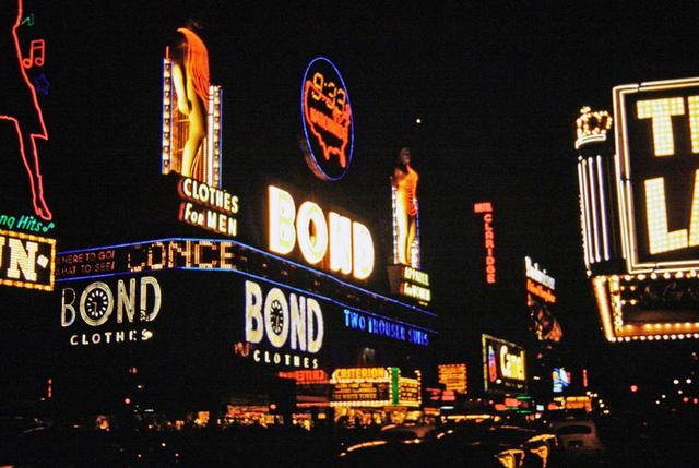 Bond statues illuminated at night with neon clothing