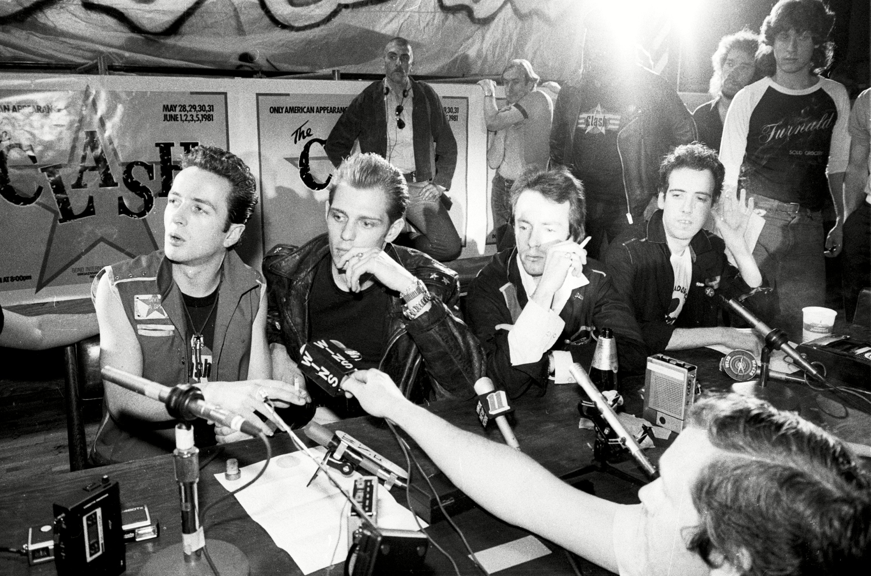 The Clash at a press desk near the Bond building in 1981, black and white